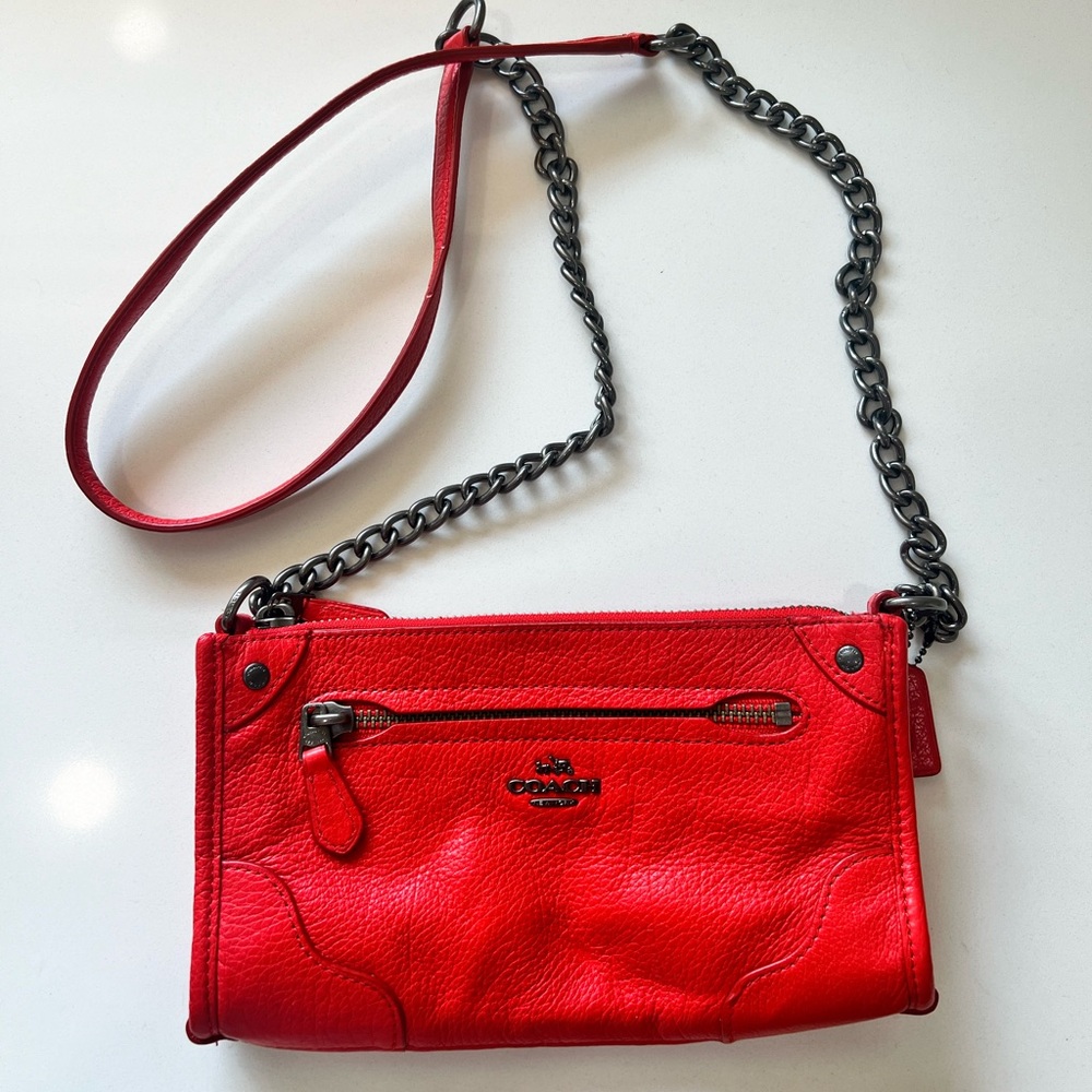 Red crossbody leather Coach purse.